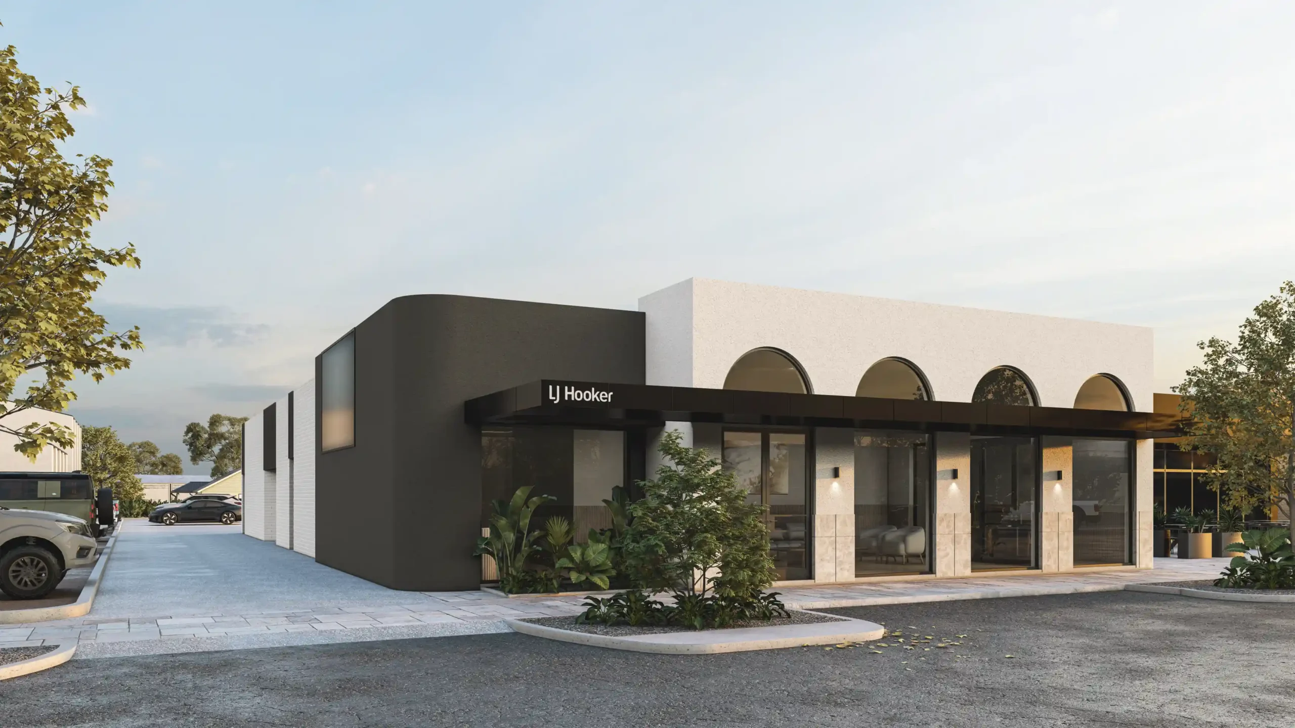 Architectural render of modern LJ Hooker commercial office building featuring dark curved corner facade, white rendered walls with arched windows, and landscaped entrance