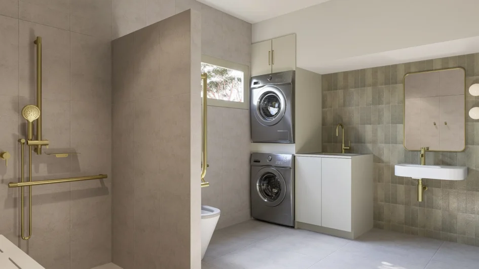 Scrase Built Kyle Andrews Foundation cabin bathroom — accessible shower, stacked laundry, brass tapware and sage tile feature wall